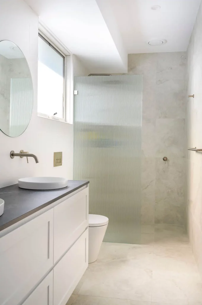 modern bathroom renovation with floor to ceiling tiles